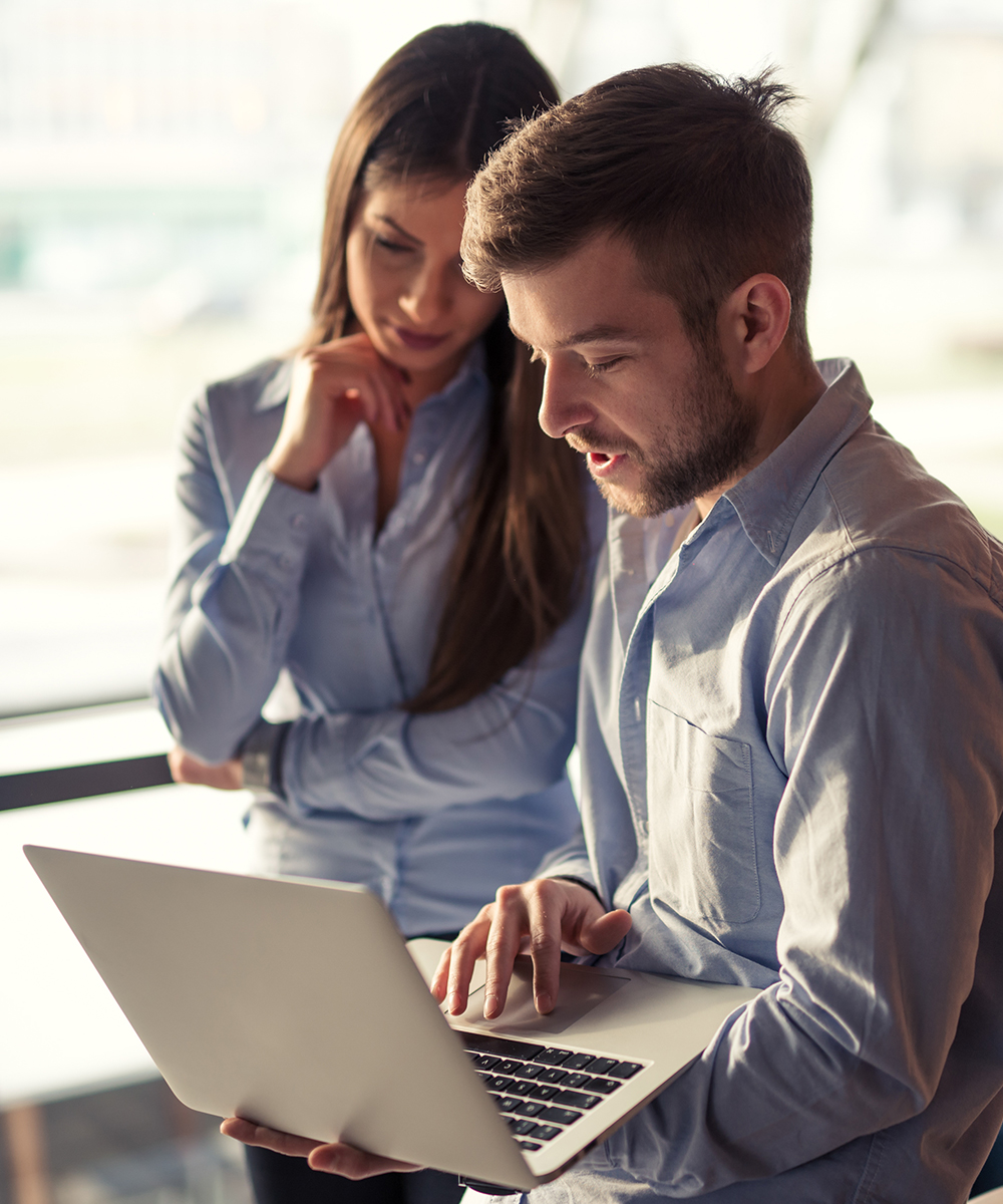 business professionals viewing a laptop