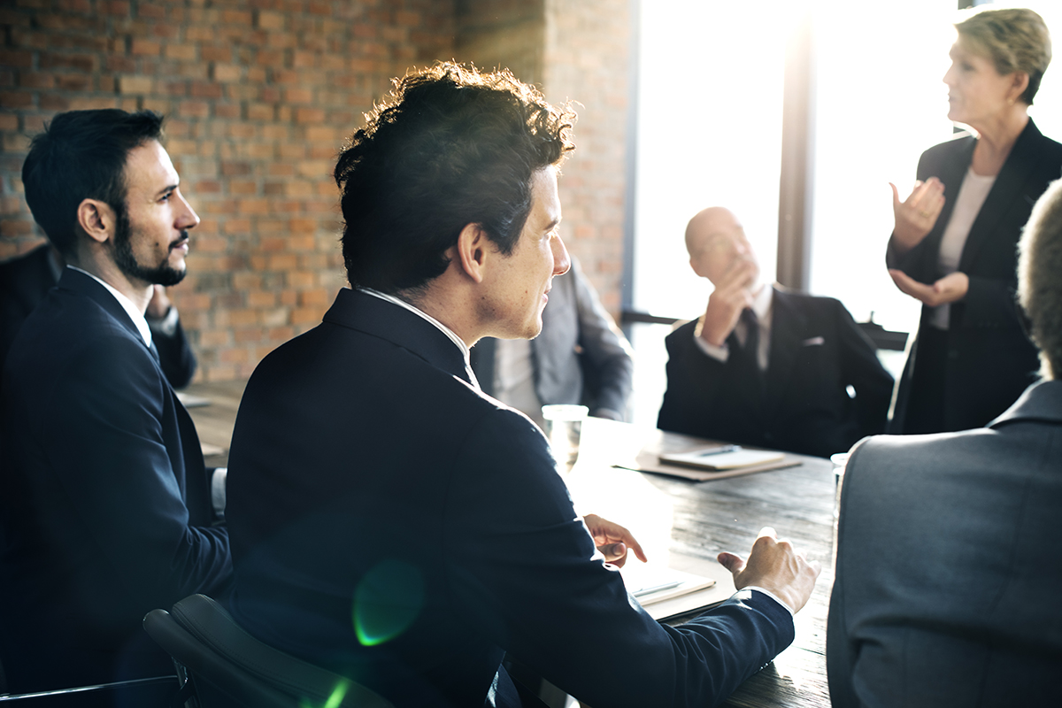 group of workers around meeting table