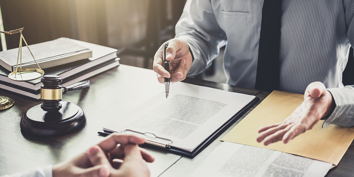 business professional explaining documents across table